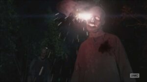 Rick kills a walker with a flare in the Walking Dead episode "The Distance"